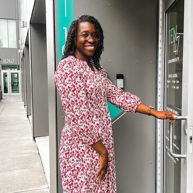 young woman entering the leasing office